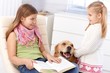 Little sisters with pet dog at home