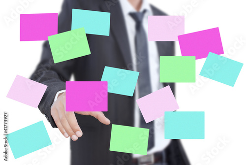 Photo: Businessman pushing sticky note on the whiteboard. Businessman pushing sticky note on the whiteboard.