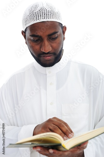 Photo: Muslim African man reading the Qoran Muslim African man reading the Qoran
