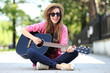 Young woman playing guitar