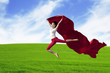 Happy woman jumping on field