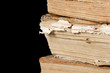 Pile of old books on black
