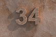 Number 34 carved from marble on marble base