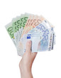 Euro banknotes in a hand isolated on white