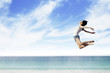 Woman flying at the beach