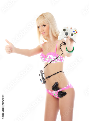 Photo: Young blonde woman in pink lingerie posing with game joysticks Young blonde woman in pink lingerie posing with game joysticks