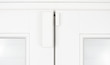 Wireless alarm sensor for window and door on white wooden sash Wireless alarm sensor for window and door on white wooden sash