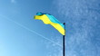 Sky with a plane and a flag of Ukraine in foreground