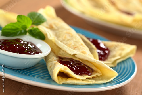 Photo: Fresh homemade crepes filled with strawberry jam Fresh homemade crepes filled with strawberry jam