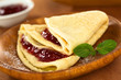 Crepe filled with strawberry jam and sprinkled with icing sugar