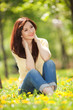Young woman in the park with flowers
