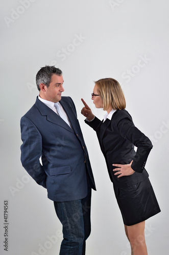 Photo: Angry business woman shouting at the her colleague's in the offi Angry business woman shouting at the her colleague's in the offi