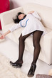 Lifeless nurse lying on the sofa