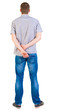 Back view of young men in  shirt and jeans.