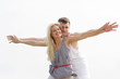 Photo: young happy couple isolated on sky background young happy couple isolated on sky background