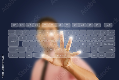 Photo: Businessman pushing keyboard on the whiteboard. Businessman pushing keyboard on the whiteboard.