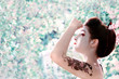 Asian woman with snake tattoo on her arm