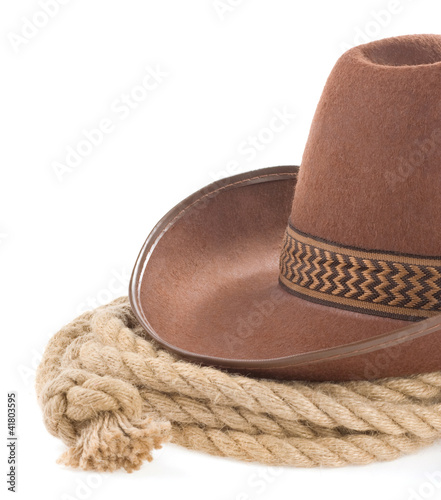 Photo: brown cowboy hat and rope isolated on white brown cowboy hat and rope isolated on white