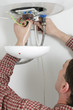 Worker installing a water heater
