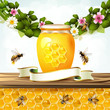 Glass jar and honey over floral background