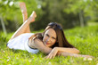 Beautiful young woman relaxing in a park Beautiful young woman relaxing in a park