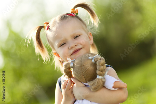 Photo: Little girl with doll Little girl with doll