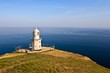 lighthouse on a marine cape at the evening