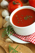 Tomato soup, fresh tomatoes, garlic and rosemary on wooden Tomato soup, fresh tomatoes, garlic and rosemary on wooden
