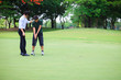 Photo: Professional golfer teaching to play golf Professional golfer teaching to play golf