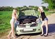 Two sexy blonde girls stand by the broken car Two sexy blonde girls stand by the broken car