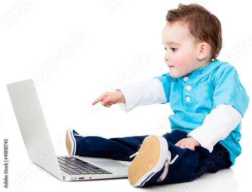 Photo: Boy pointing at a laptop Boy pointing at a laptop
