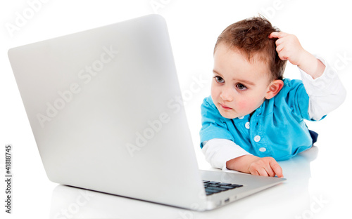 Photo: Confused boy with a computer Confused boy with a computer