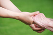 Senior and Young Women Holding Hands