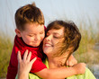 Portrait of happy mother and son hugging at beach Portrait of happy mother and son hugging at beach