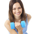 Young woman exercising with dumbbell, isolated Young woman exercising with dumbbell, isolated