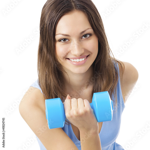 Photo: Young woman exercising with dumbbell, isolated Young woman exercising with dumbbell, isolated