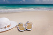 hat and flip-flops on the beach
