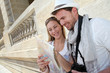 Couple of tourists looking at city tour map