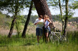 Couple on a bike ride making a stop to look at map Couple on a bike ride making a stop to look at map
