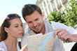 Couple of tourists looking at city tour map Couple of tourists looking at city tour map