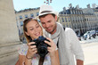 Couple enjoying taking pictures while visiting city