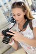 Portrait of young tourist looking at camera screen Portrait of young tourist looking at camera screen