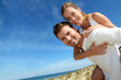 Man giving piggyback ride to girlfriend on a sand dune