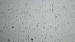 Raindrops slowly flowing on a glass