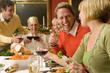 Family having Christmas dinner, portrait of mature man smiling