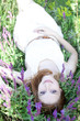 Young fashion girl lying down at green grass.