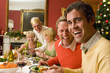 Family having Christmas dinner, portrait of men smiling
