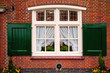 Photo: Old retro window with shutters on red brick house Old retro window with shutters on red brick house