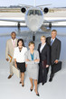 Photo: Small group of people in line behind woman by aeroplane on runway, portrait, elevated view Small group of people in line behind woman by aeroplane on runway, portrait, elevated view