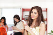 Girls texting on cell phones, with front focus